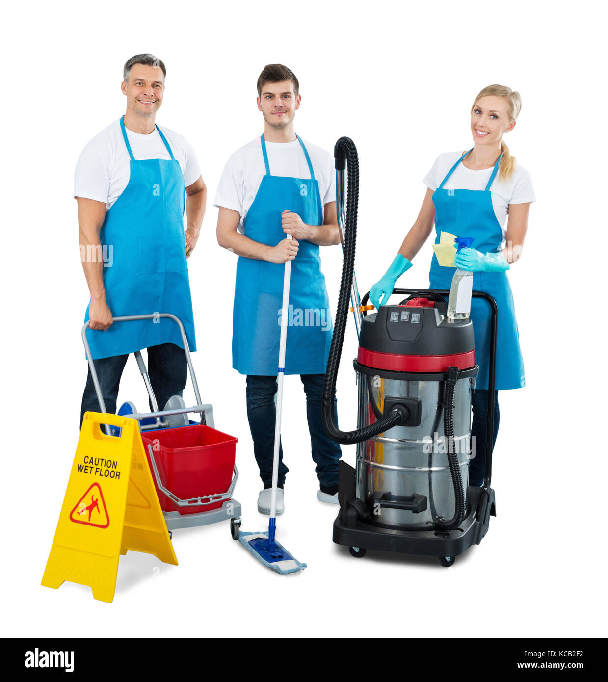 Group Of Janitors With Their Cleaning Equipment Standing On White Background Stock Photo