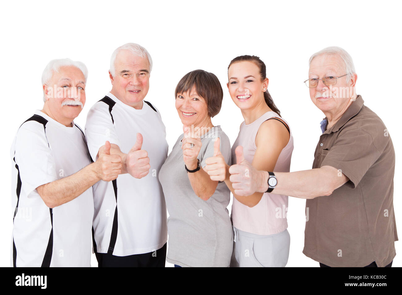 Group Of Senior People Showing Thumbs Up In Front Of White Background Stock Photo
