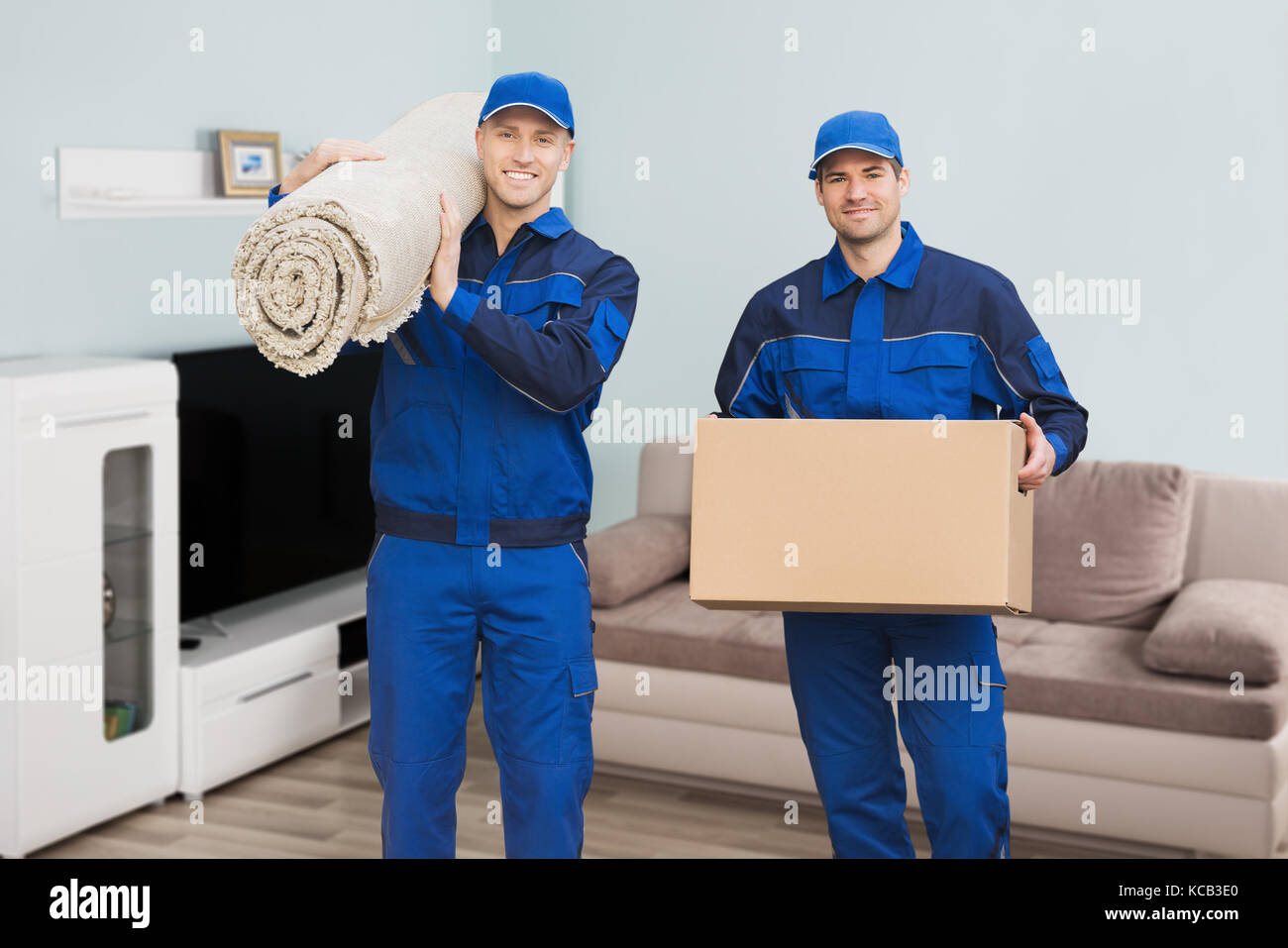 Two men carrying carpet hires stock photography and images Alamy