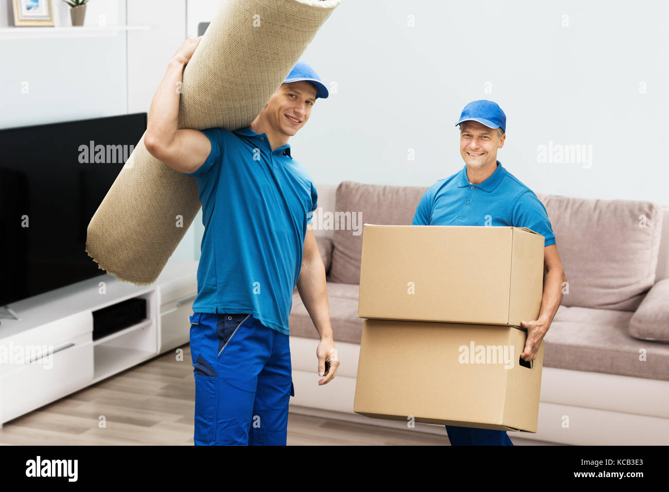 Two men carrying carpet hires stock photography and images Alamy