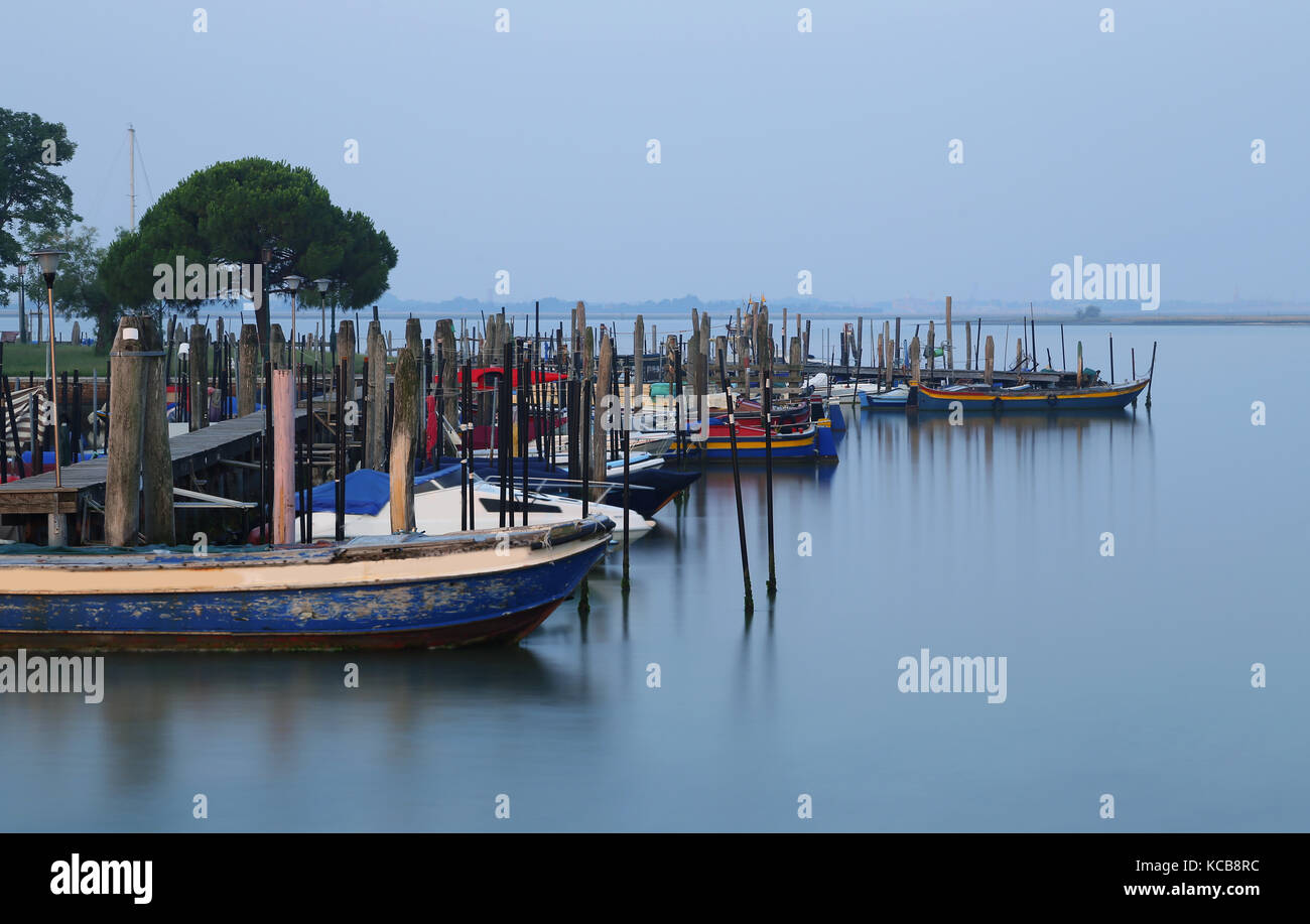 many boats in the Adriatic Sea at sunrise in the Burano Island near Venice in Italy Stock Photo