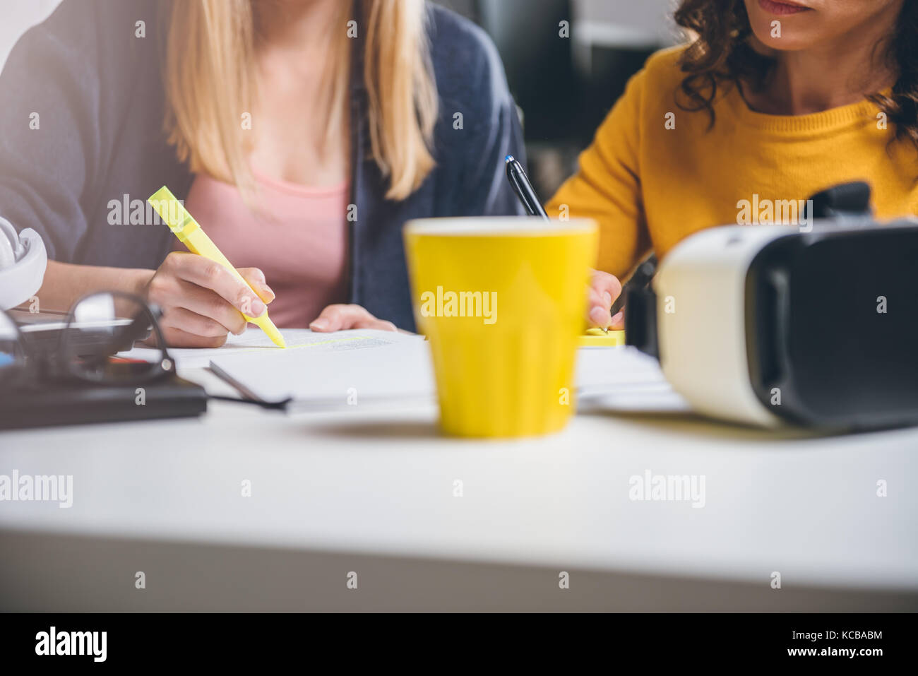 Two business woman working together at the office Stock Photo - Alamy