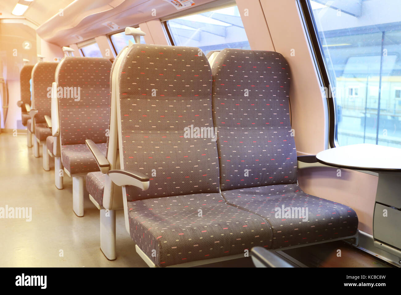 Interior of modern european train. New empty railway carriage. Stock Photo