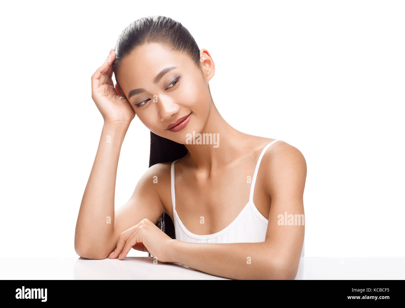 Beauty portrait of cute Asian woman with dreaming face. Young model smiling and looking to the side. Spa, clean skin, beauty treatments concept photo  Stock Photo