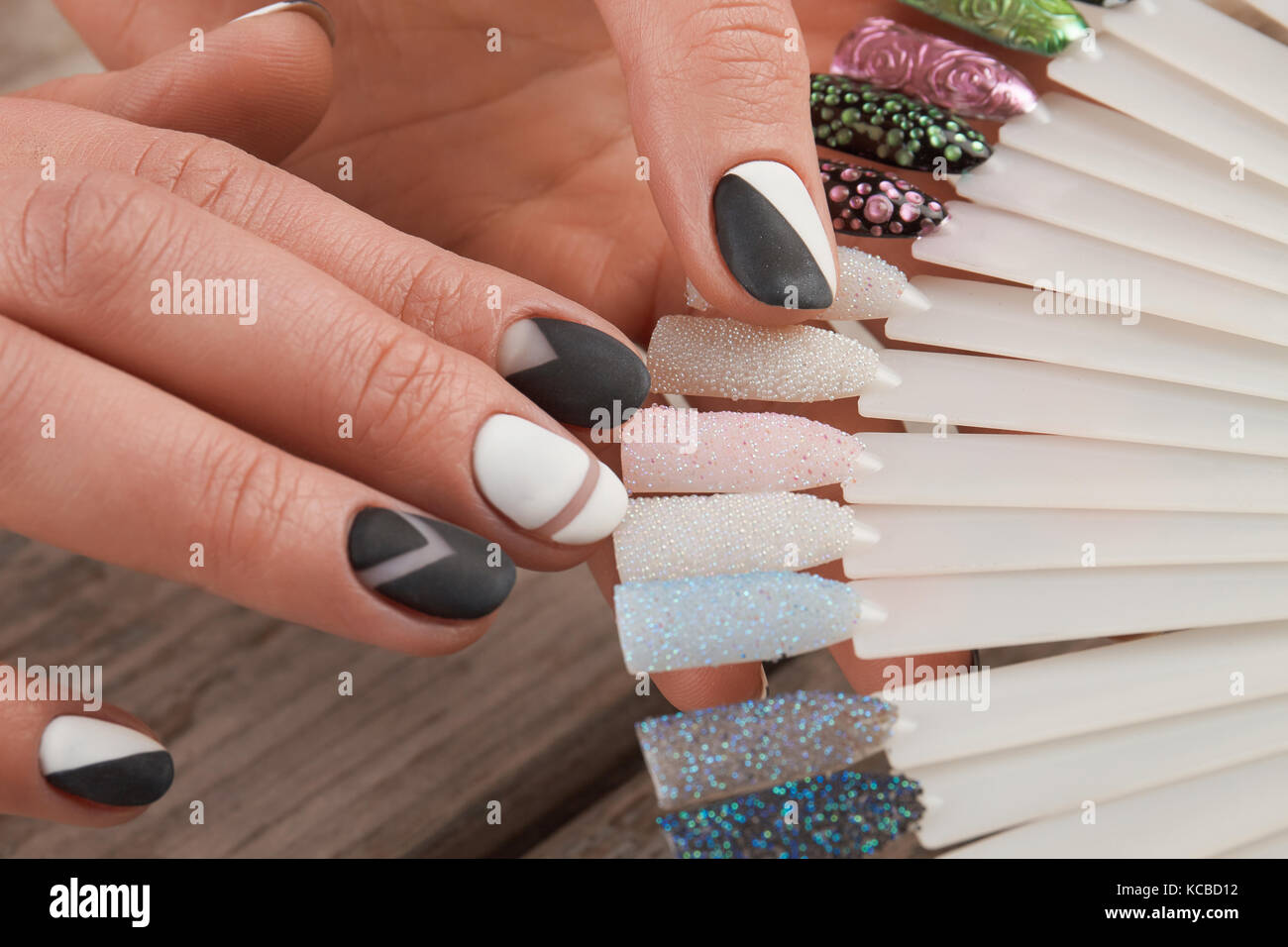 Fashion nail art samples in female hands. Stock Photo