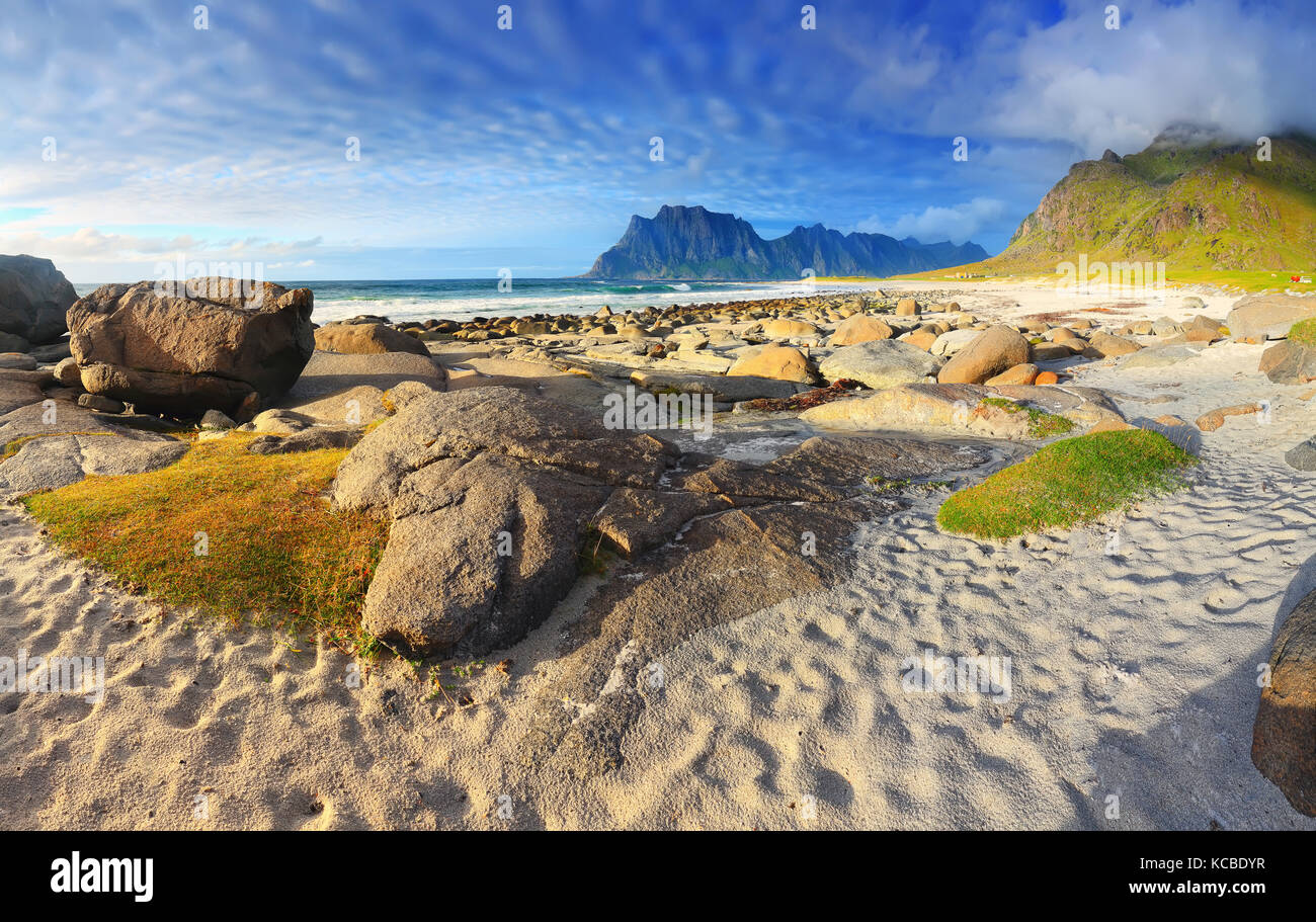 North beach of Norway with white sand in the sunny evening. Summer landscape of Uttakleiv beach on Lofoten islands. Stock Photo