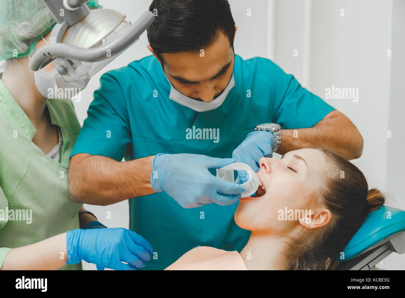Doctor dentist puts the retractor to the patient Stock Photo - Alamy
