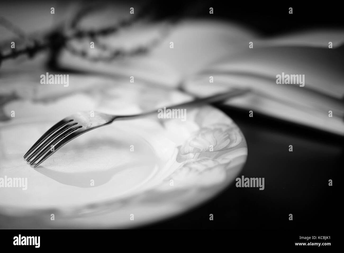 fork in plate black white Stock Photo