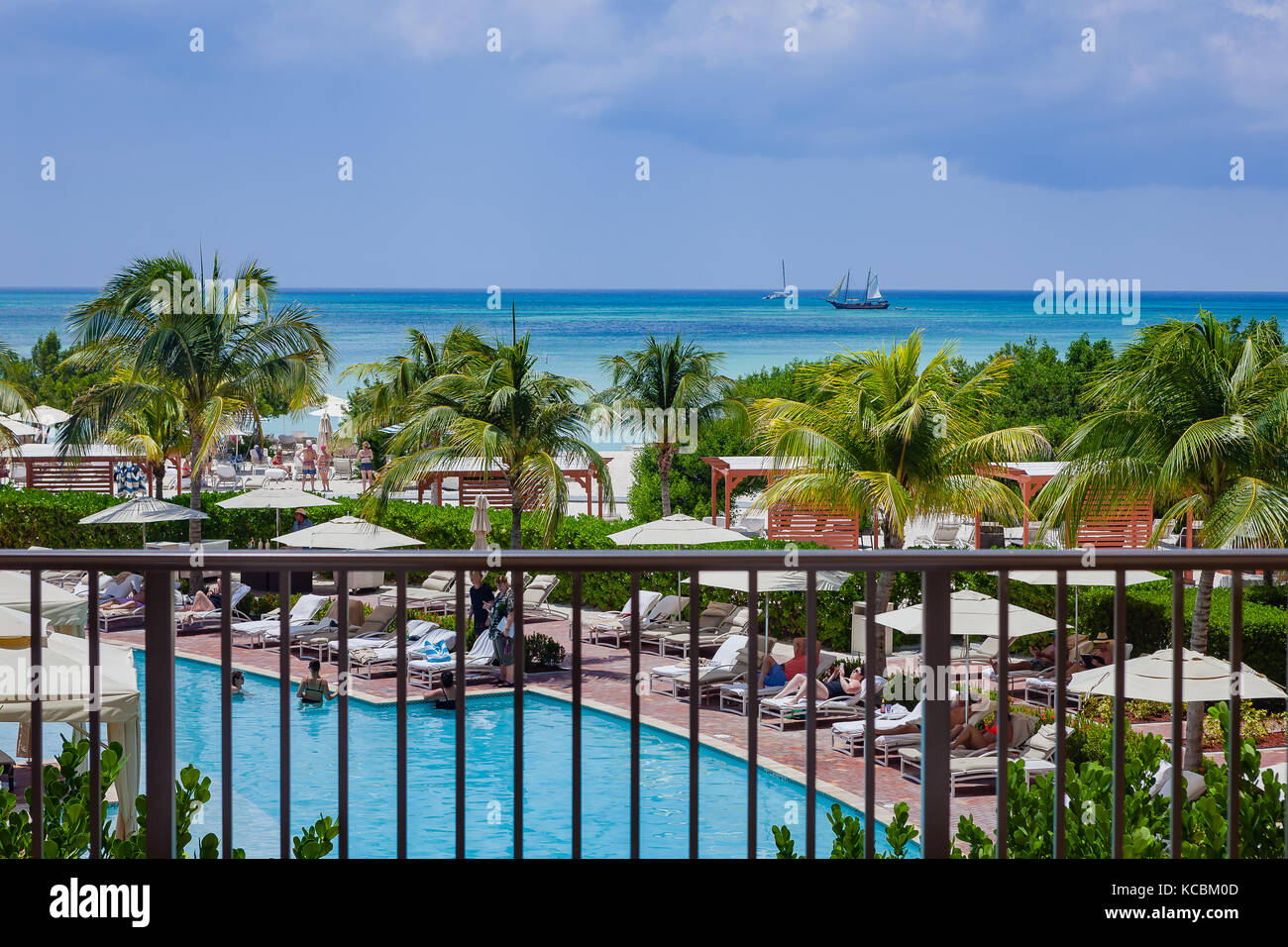 Aruba - A view of the South Caribbean Sea from Palm Beach on the Island of Aruba. Foreground: Coconut Palms and a  section of the Ritz-Carlton Hotel Stock Photo