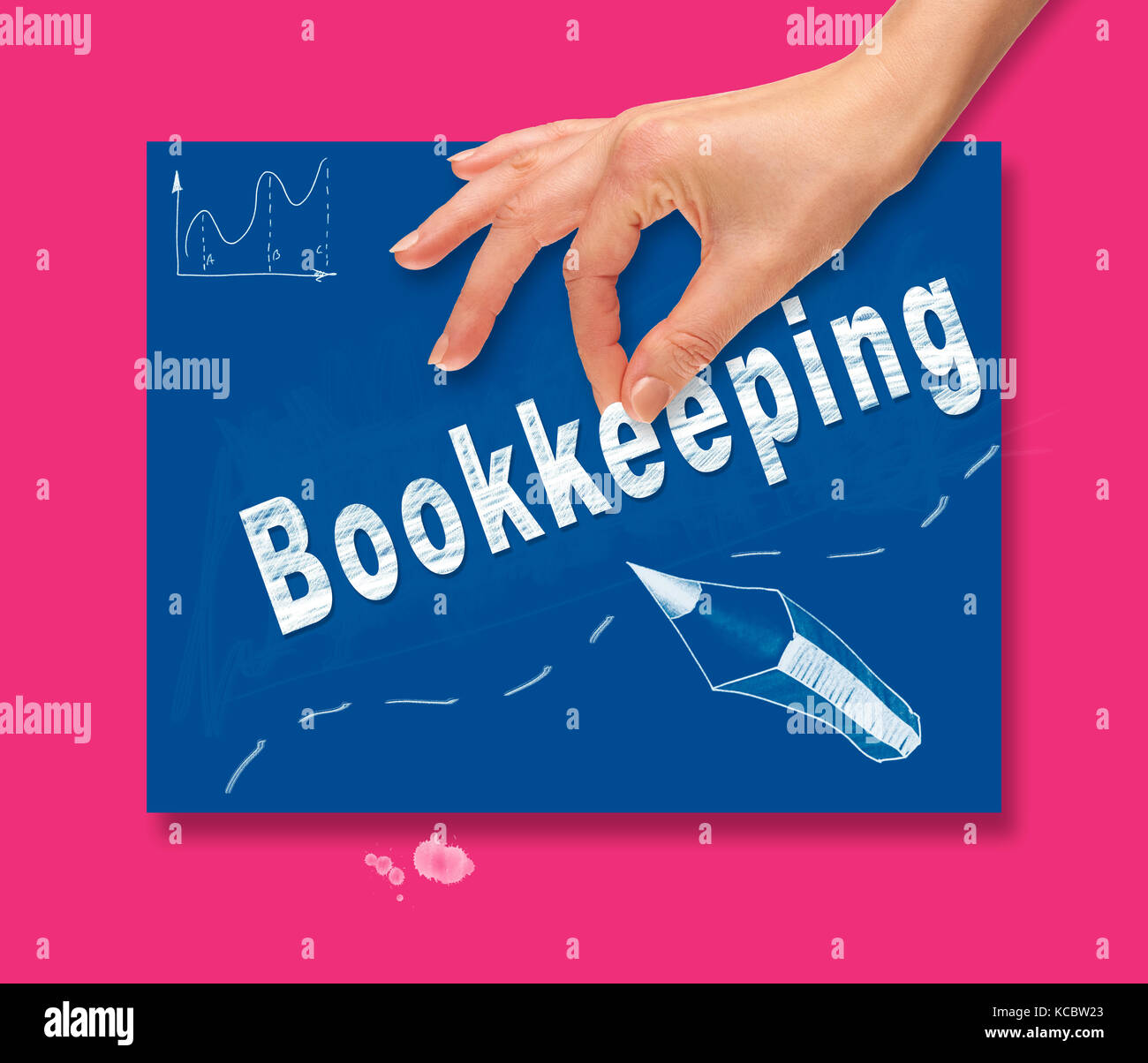 A hand picking up a Bookkeeping concept on a colorful drawing board. Stock Photo