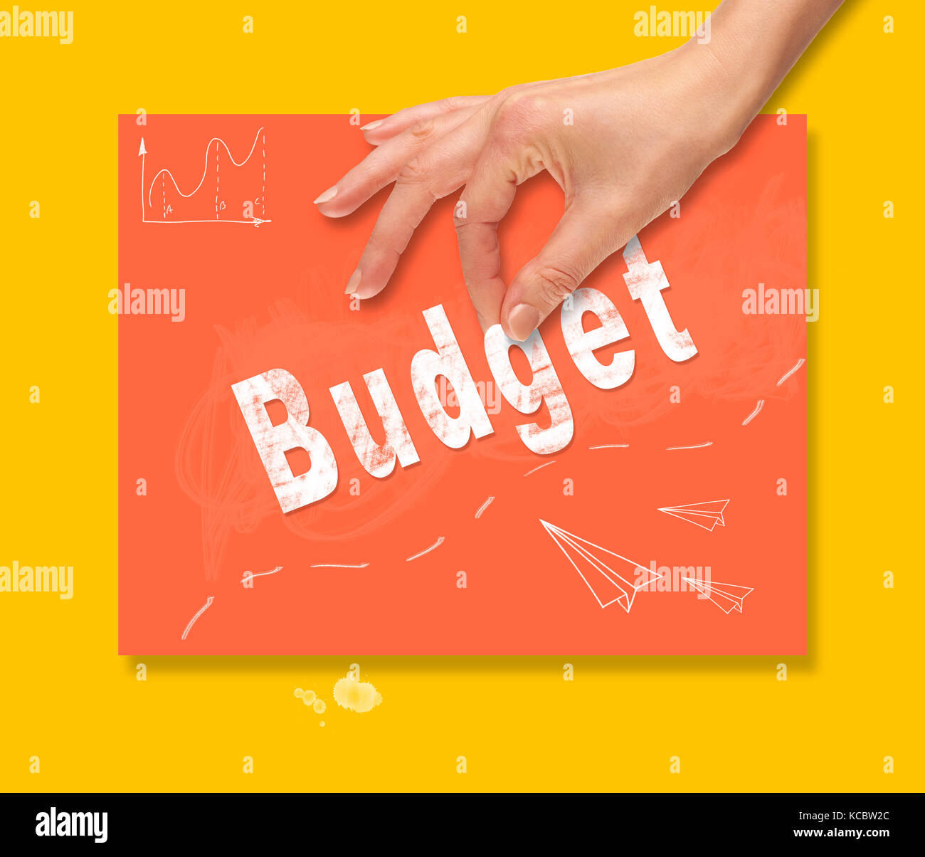 A hand picking up a Budget concept on a colorful drawing board Stock ...