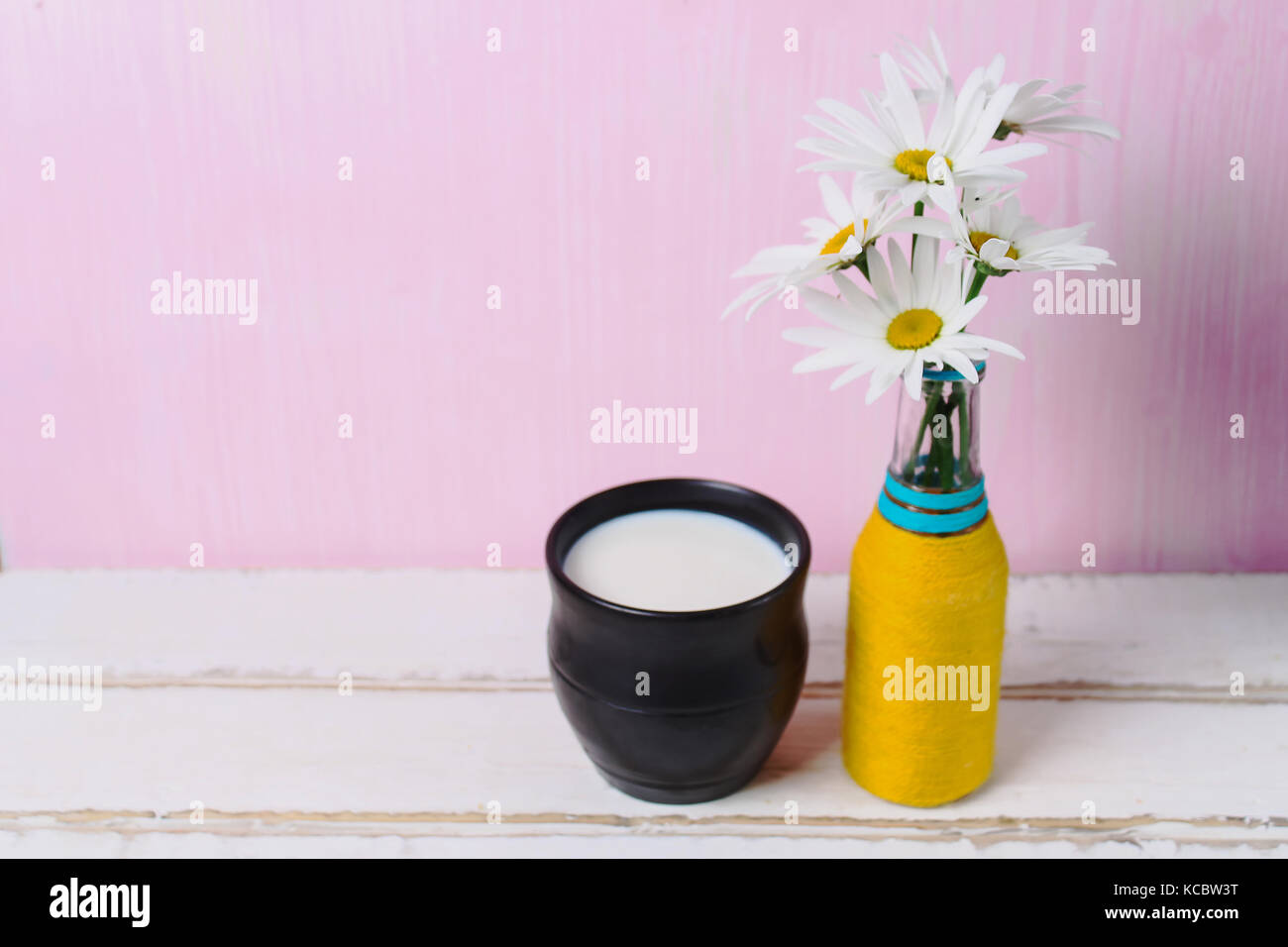 Flowers and milk on the table Stock Photo Alamy
