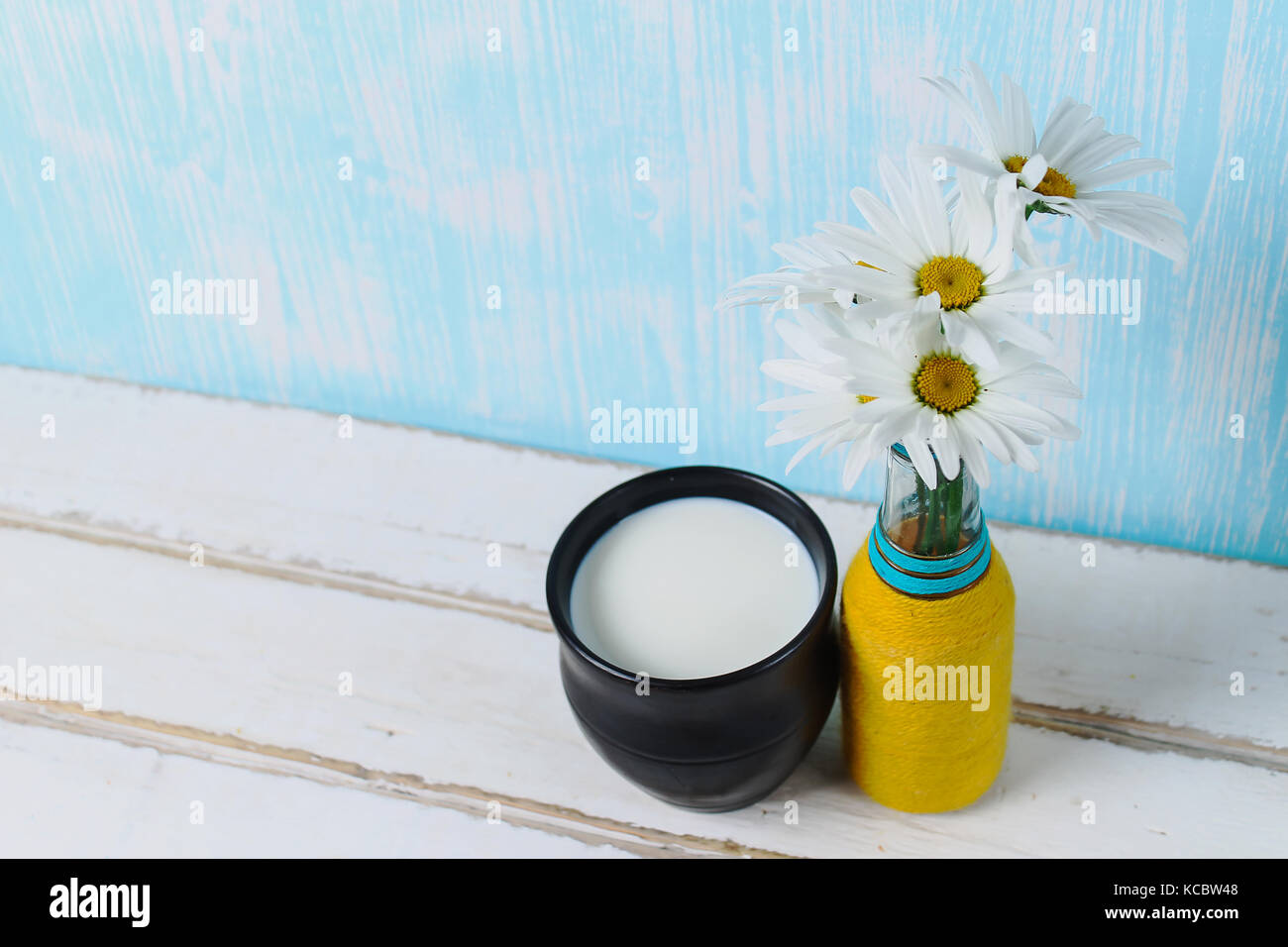 Flowers and milk on the table Stock Photo Alamy