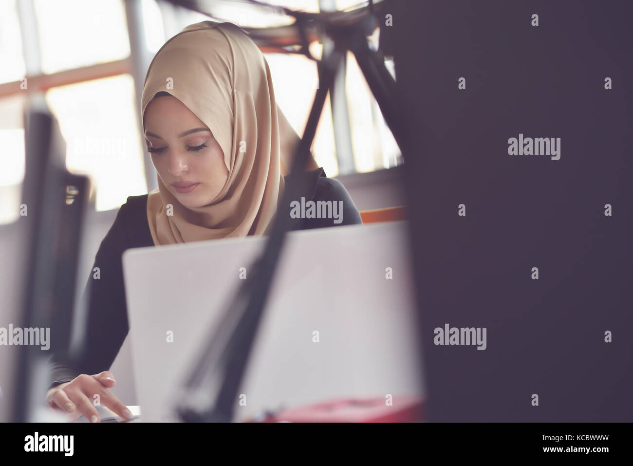 Muslim asian woman working in office with laptop Stock Photo - Alamy