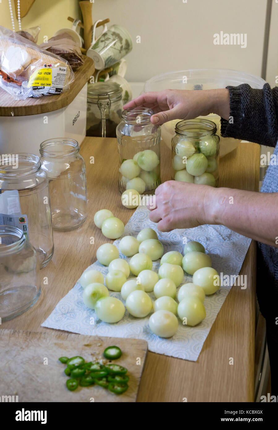pickling onions in kitchen Stock Photo