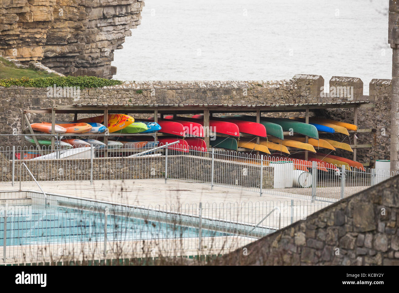 outdoor persuits kayak storage by coastal swimming pool Stock Photo