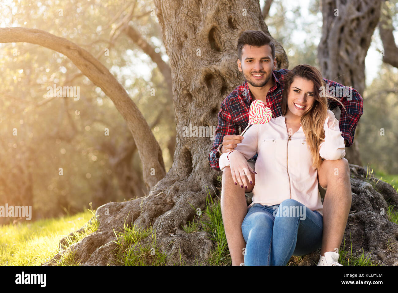 Young beautiful couple under tree in beautiful nature Alamy
