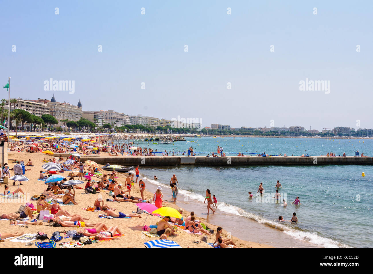 Vacationers enjoy the beautiful weather on the public beach Cannes