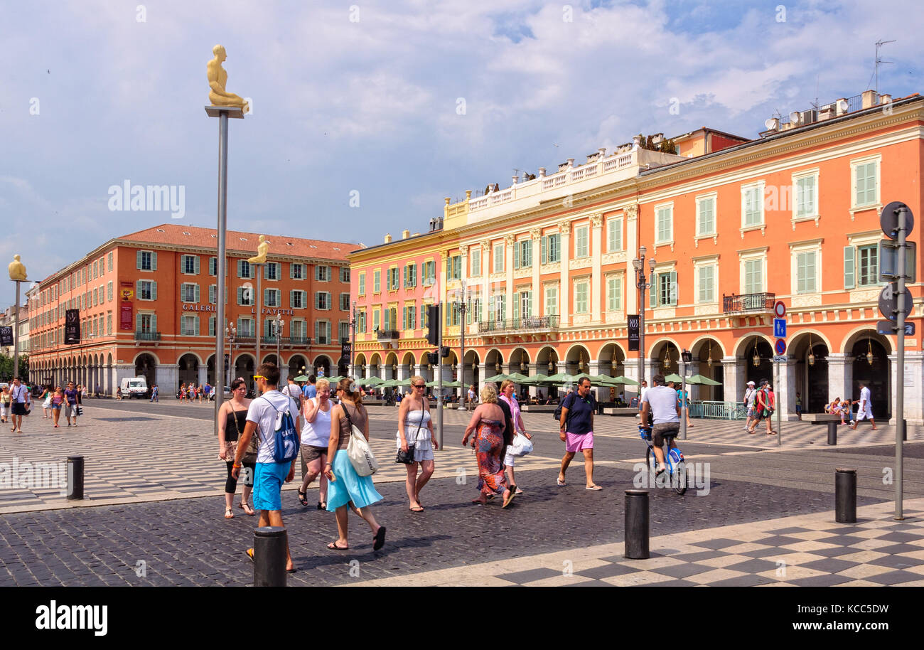 Place Massena is the largest and most spectacular square of Vieux Nice bordered by buildings with impressive red facades - Nice, France Stock Photo