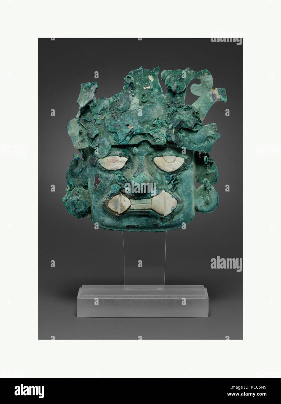 Ornamental mask, 390–450, Peru, Moche (Loma Negra), Silvered copper, shell, H. 3 3/4 x W. 3 15/16 in. (9.5 x 10 cm), Metal Stock Photo