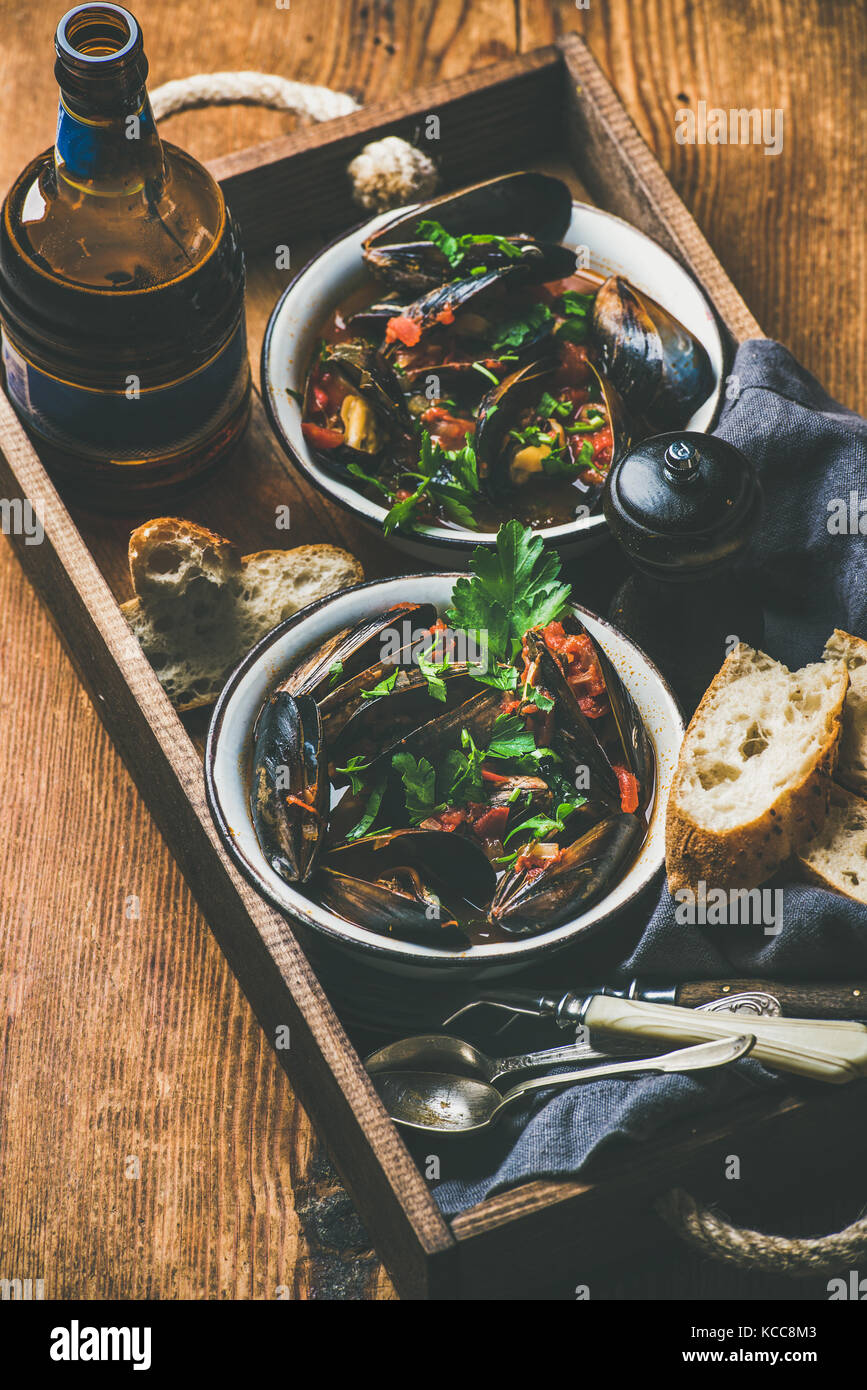 Belgian boiled mussels in tomato sauce and beer in bottle Stock Photo