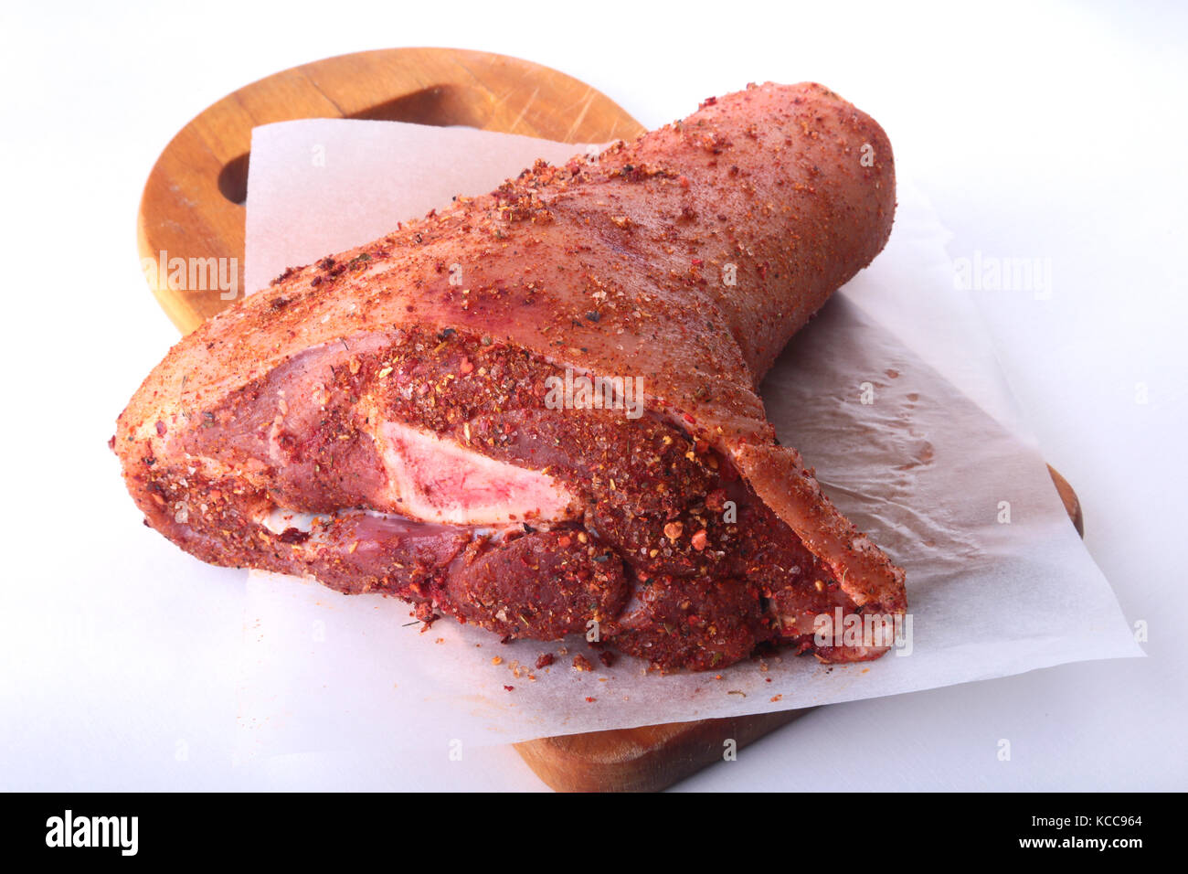 Raw pork knuckle and spices on a cutting board. Selective focus. Ready