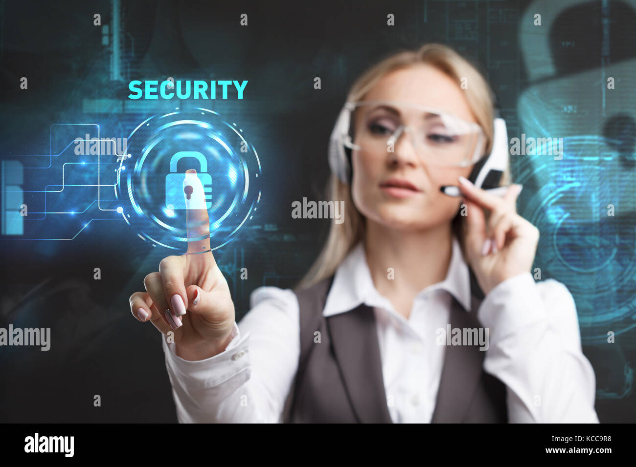Young businesswoman working in virtual glasses, select the icon security on the virtual display Stock Photo