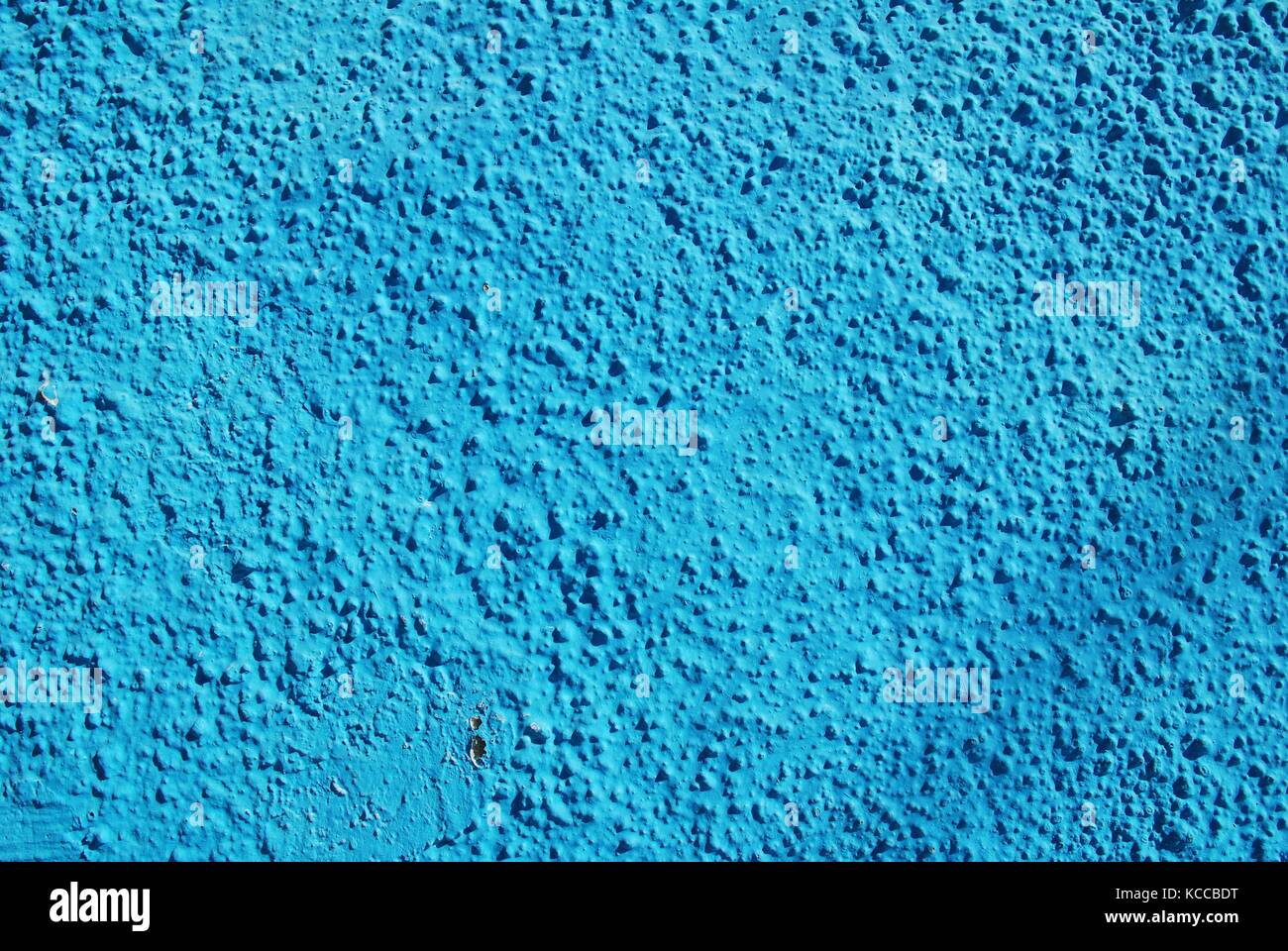 Background image of a blue painted wall of a building on the Greek island of Symi. Stock Photo