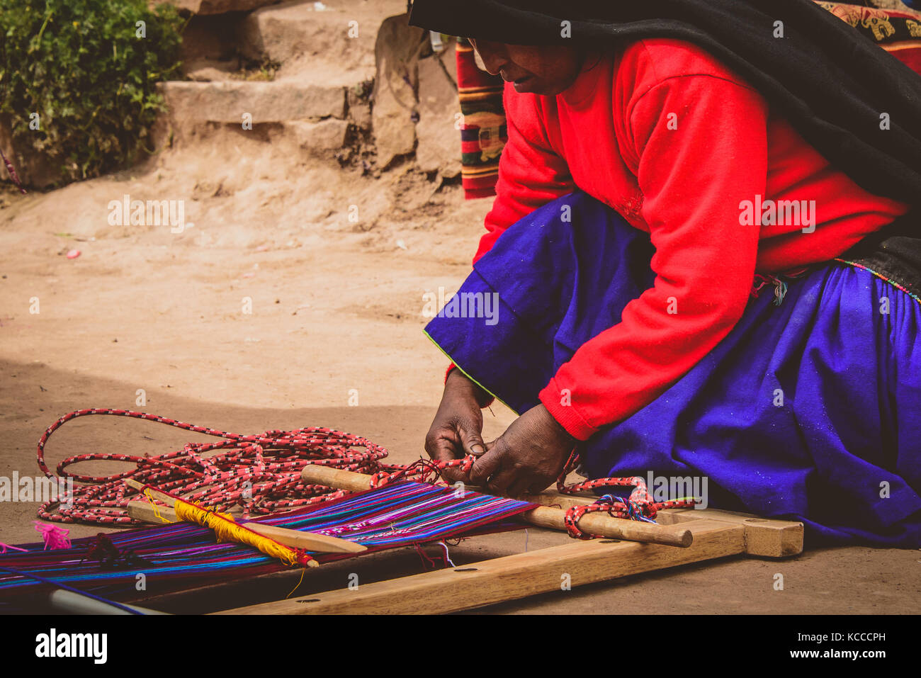 Peruvian lady weaving Stock Photo