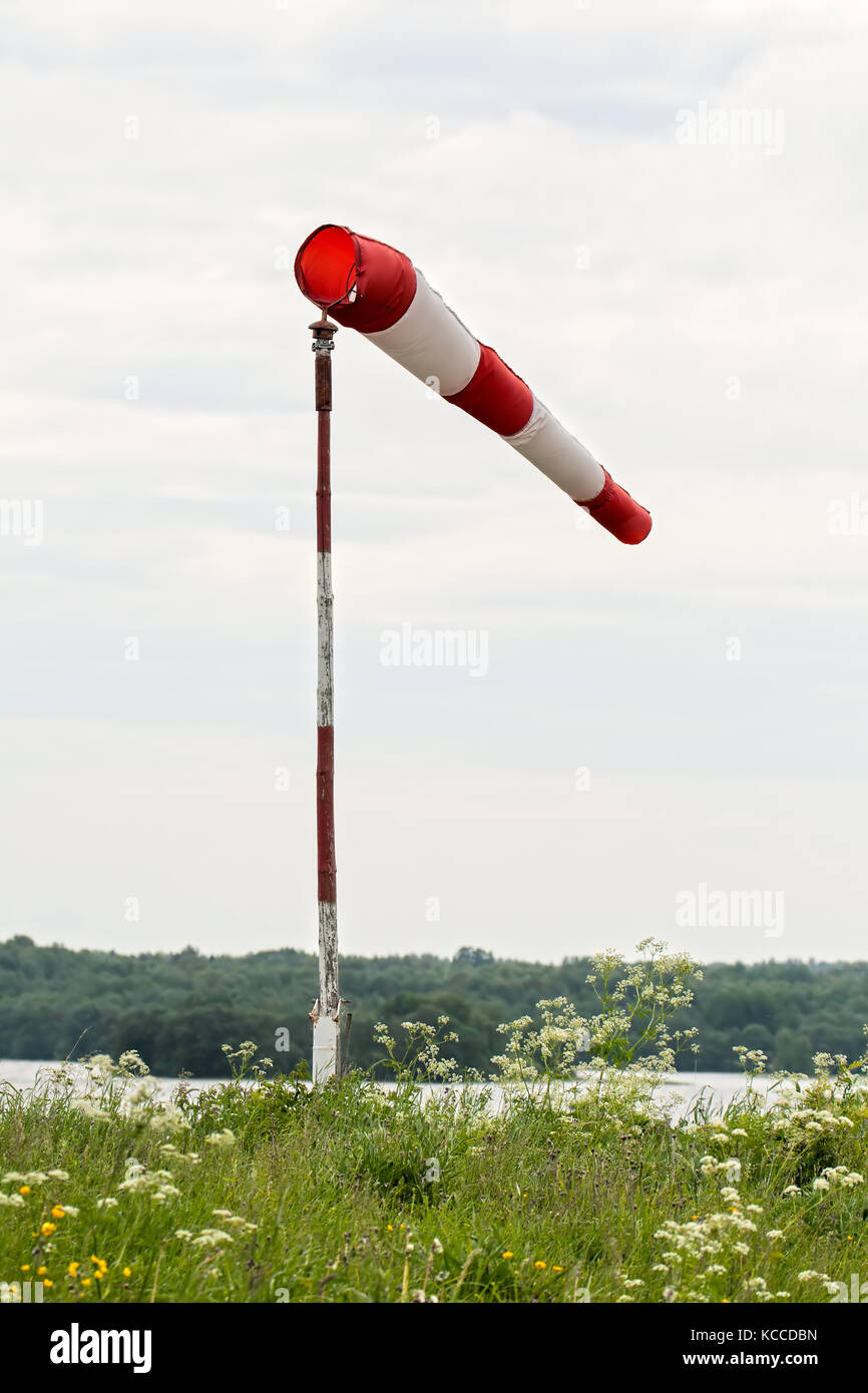 Windsock on the shore of lake, strong wind Stock Photo