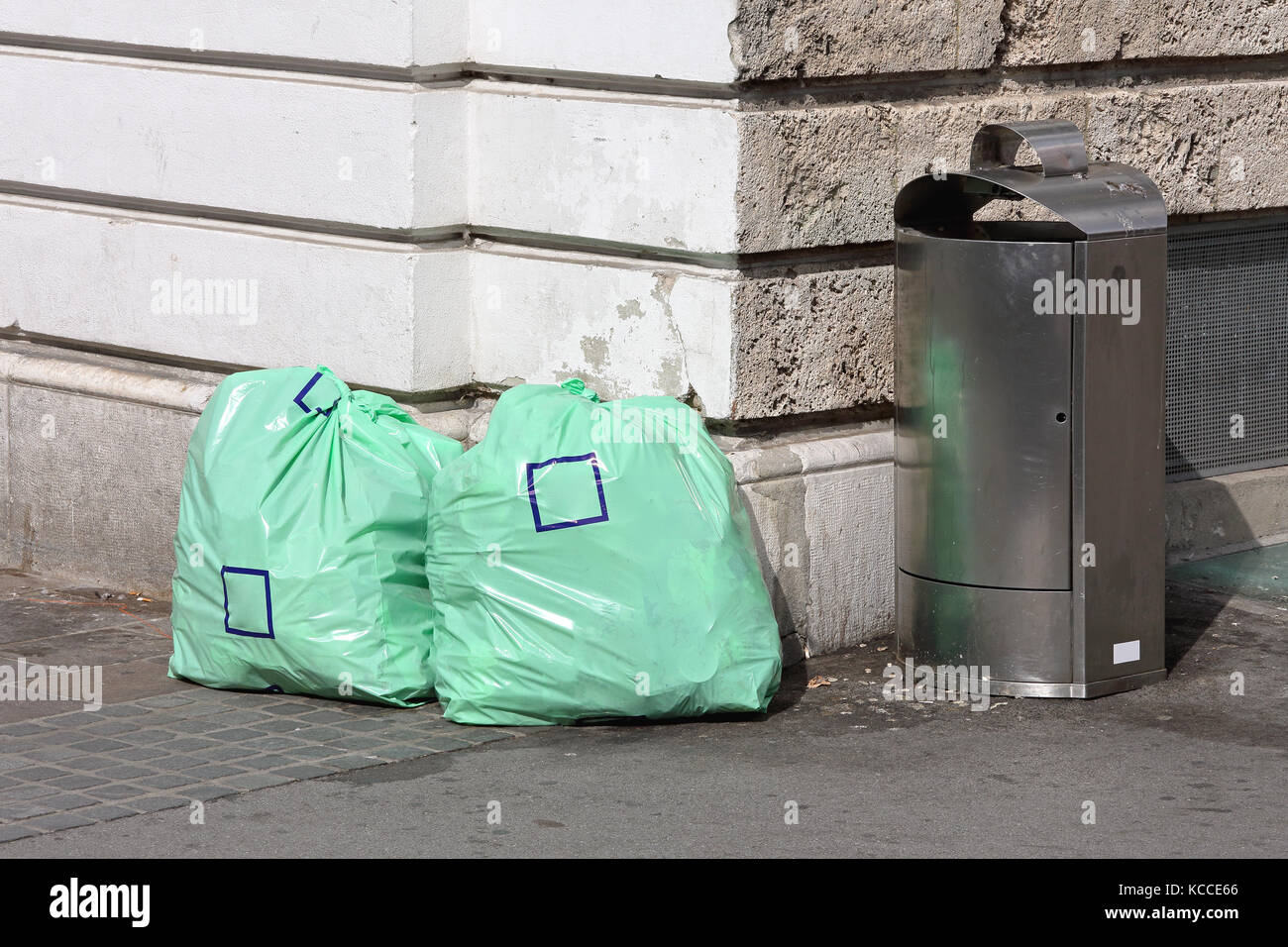 Trash Bin and Two Garbage Bags at Street Corner Stock Photo Alamy
