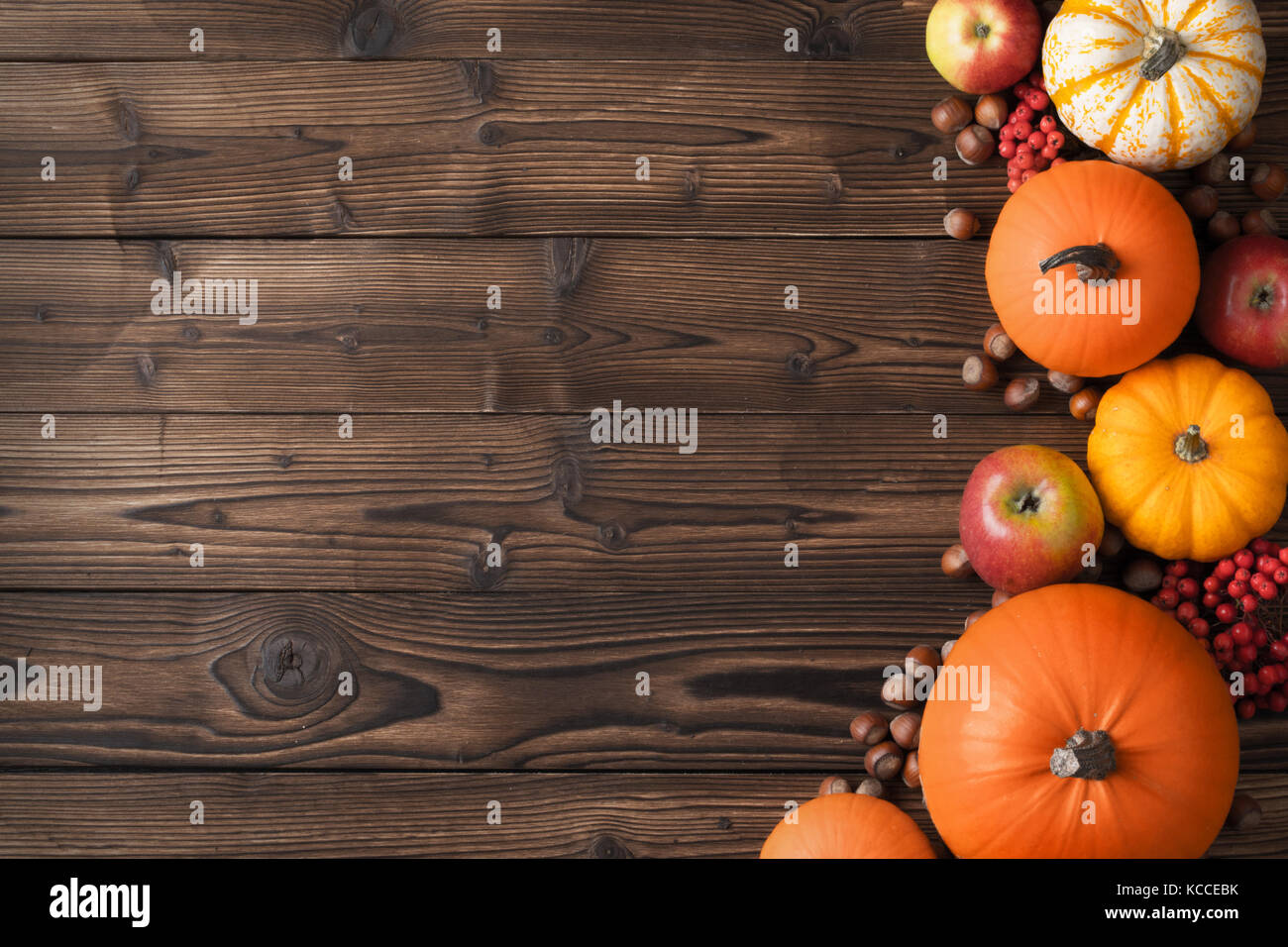 Autumn harvest still life with pumpkins, apples, hazelnuts and ...