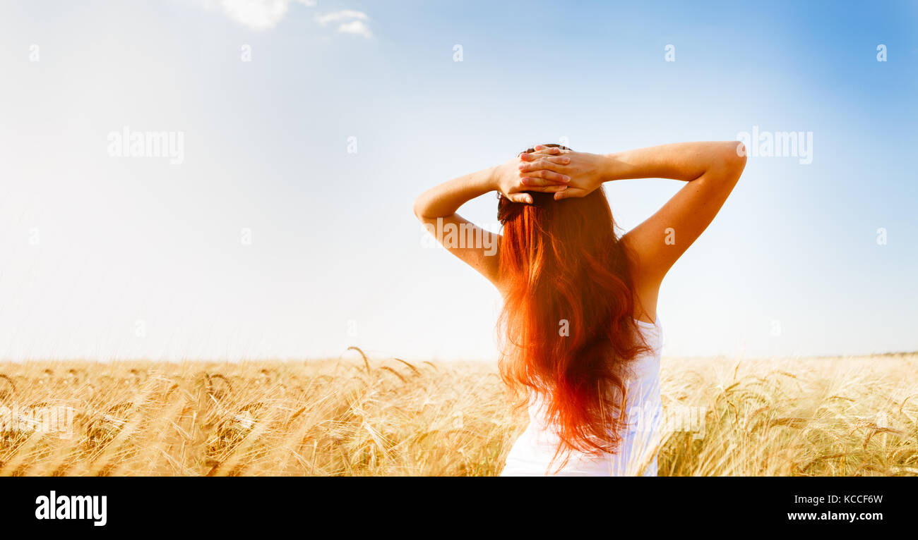 Image from back woman on wheat field Stock Photo