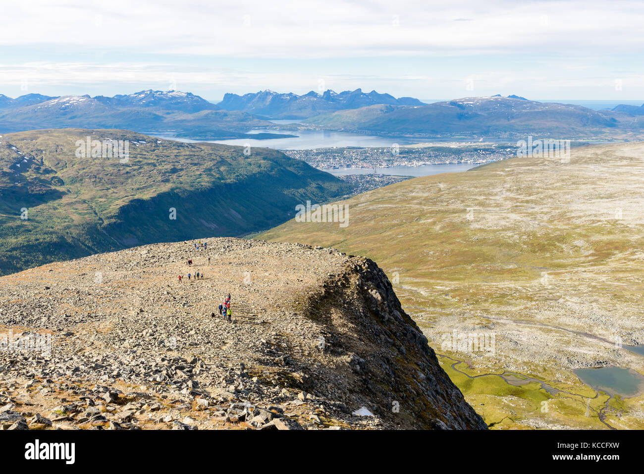 Picture is taken on a hike up Tromsdalstinden, direction west. A group of people are visible. Tromsø, Norway. Stock Photo
