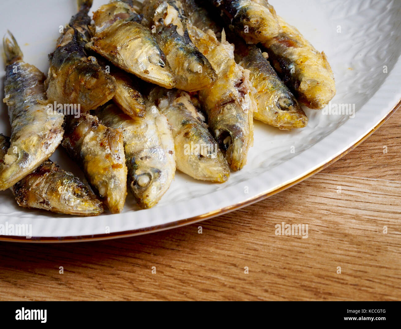 Fried small sardine on a plate Stock Photo - Alamy
