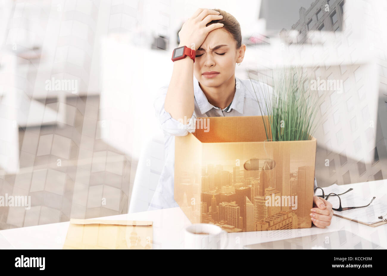 Depressed unemployed woman sitting in the office Stock Photo