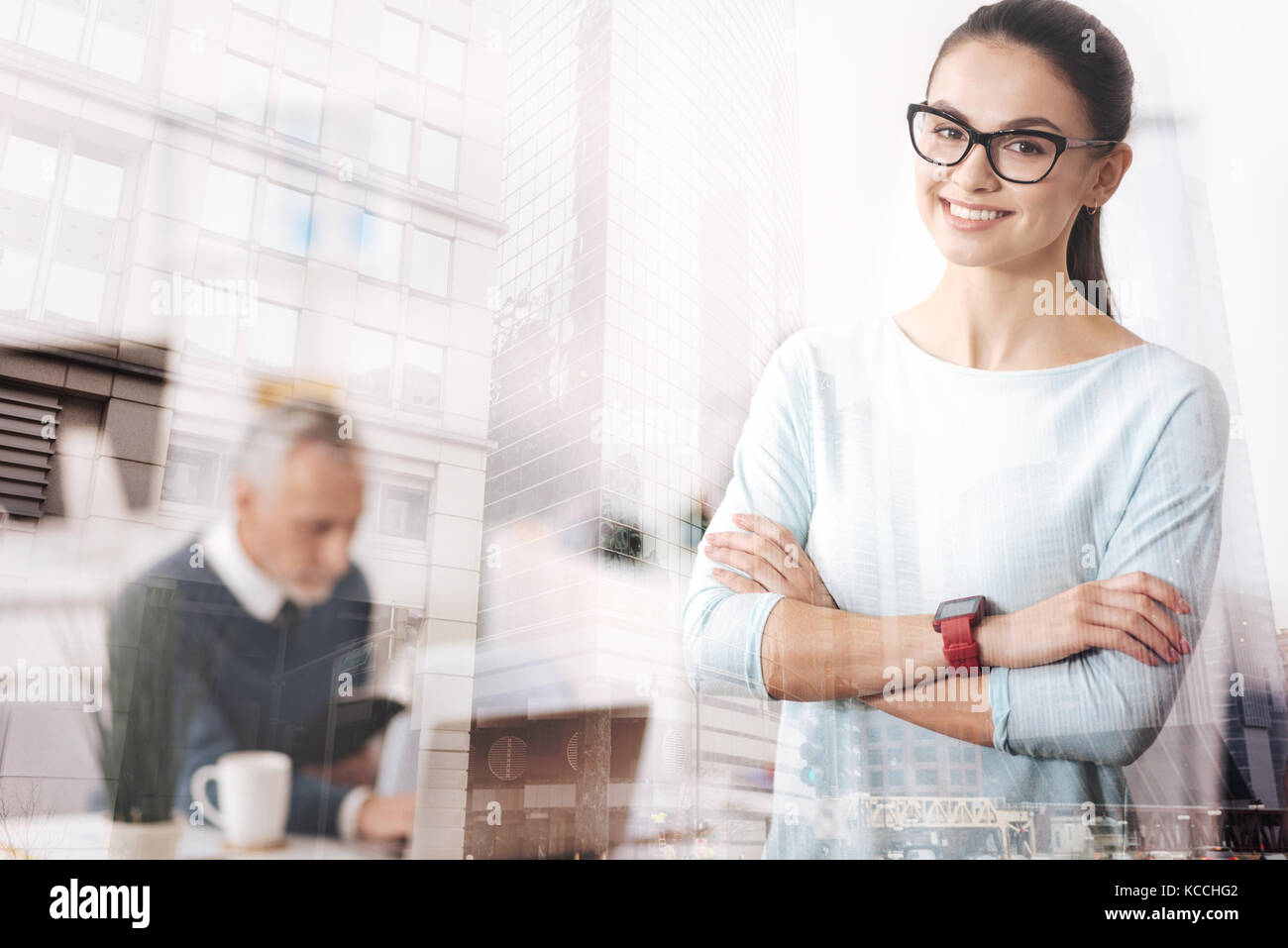 Cheerful young woman standigng in the office Stock Photo