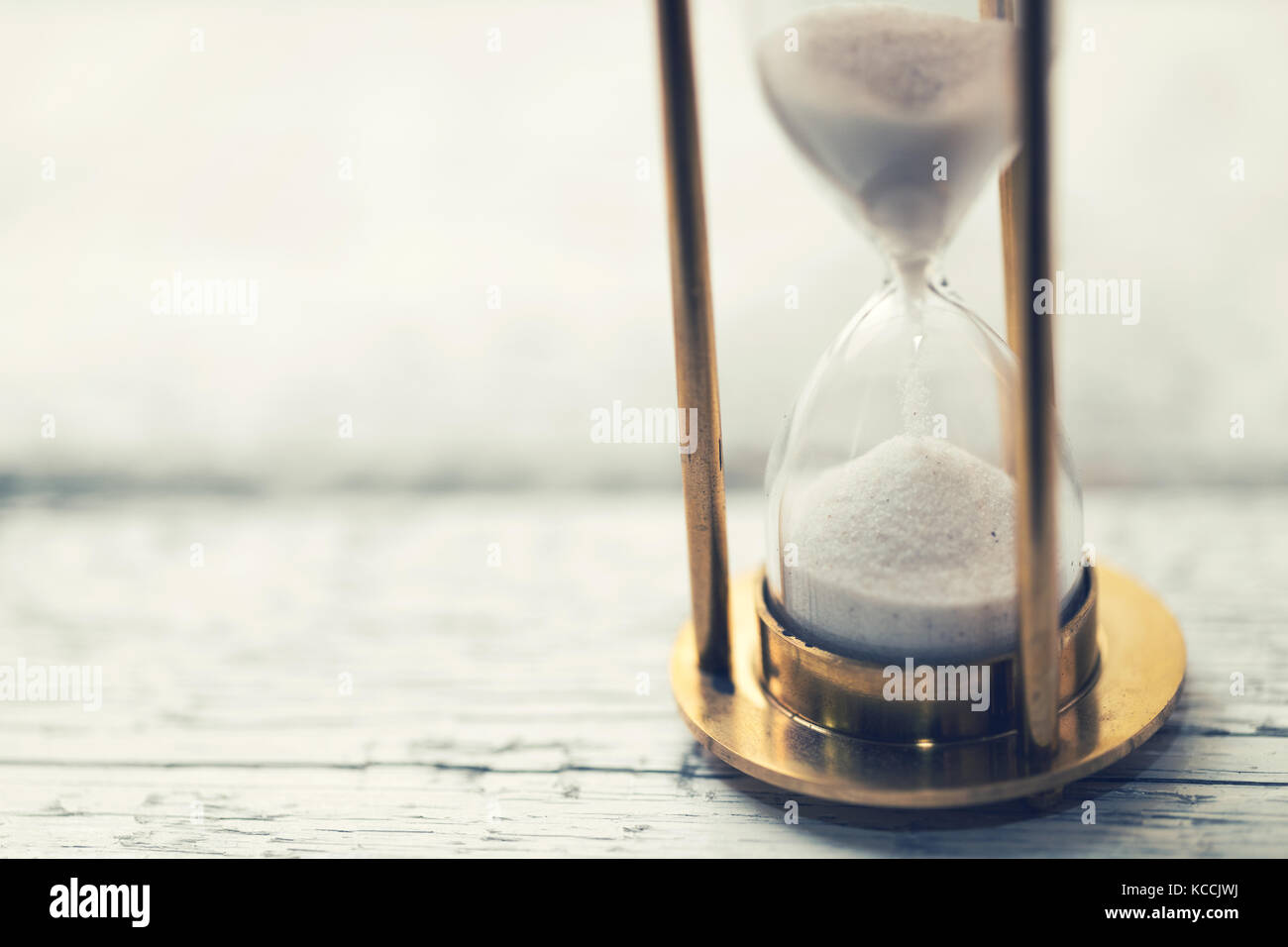 time is ticking - hourglass on the table with copy space Stock Photo