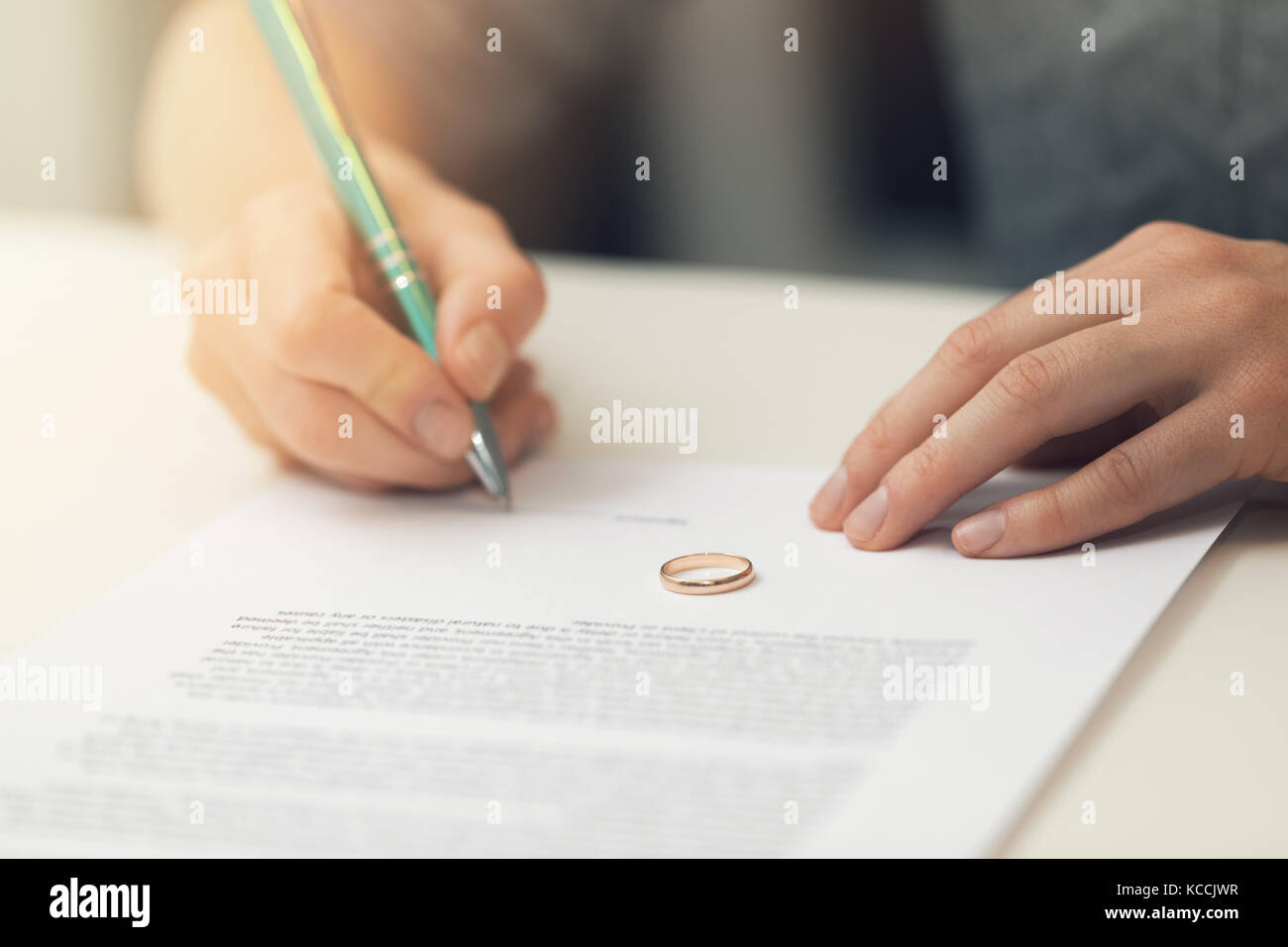 woman signing marriage divorce papers Stock Photo