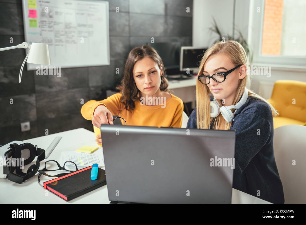 Two business woman using computer at the office Stock Photo