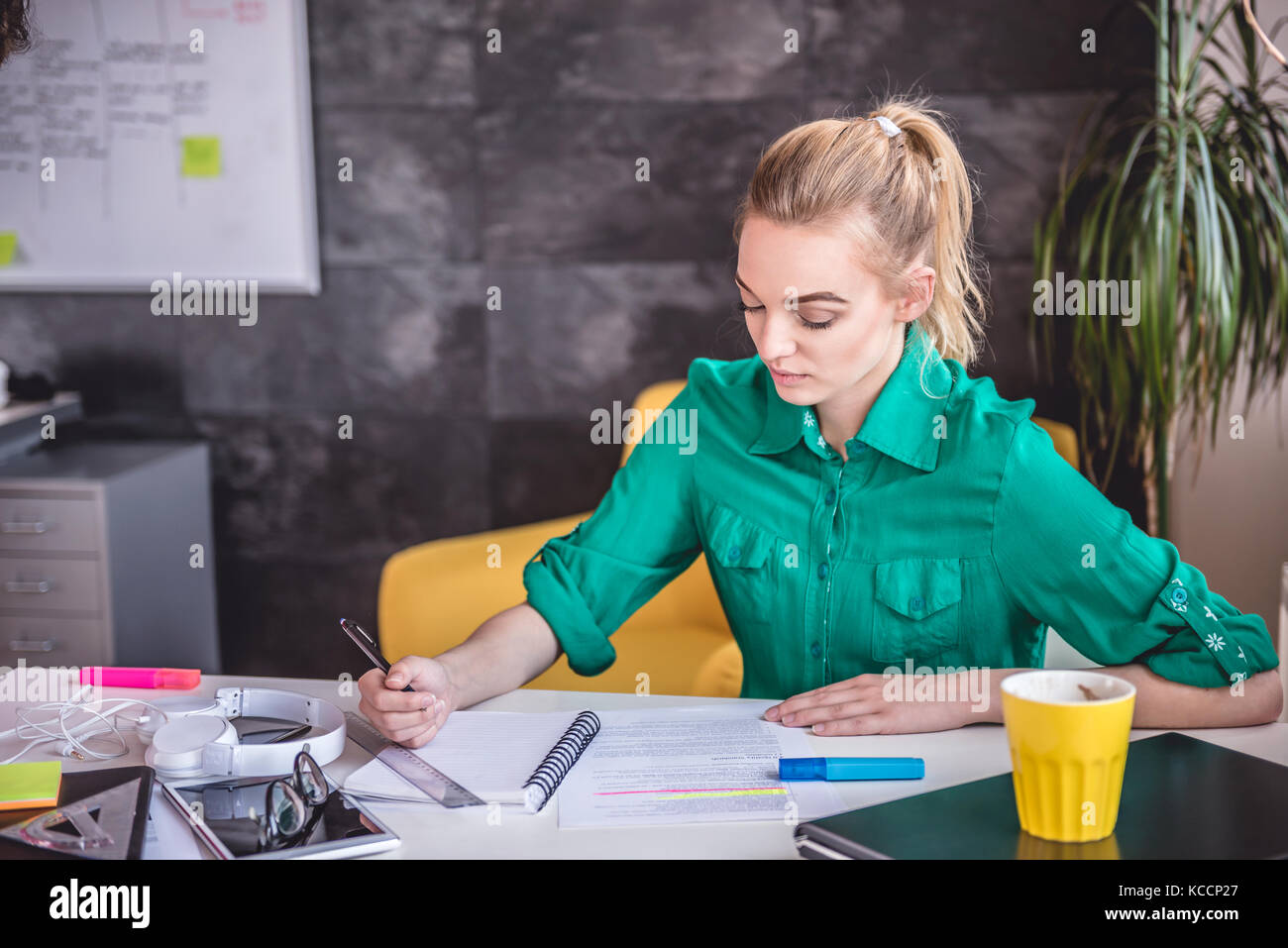 Young business woman doing paperwork in the office Stock Photo - Alamy