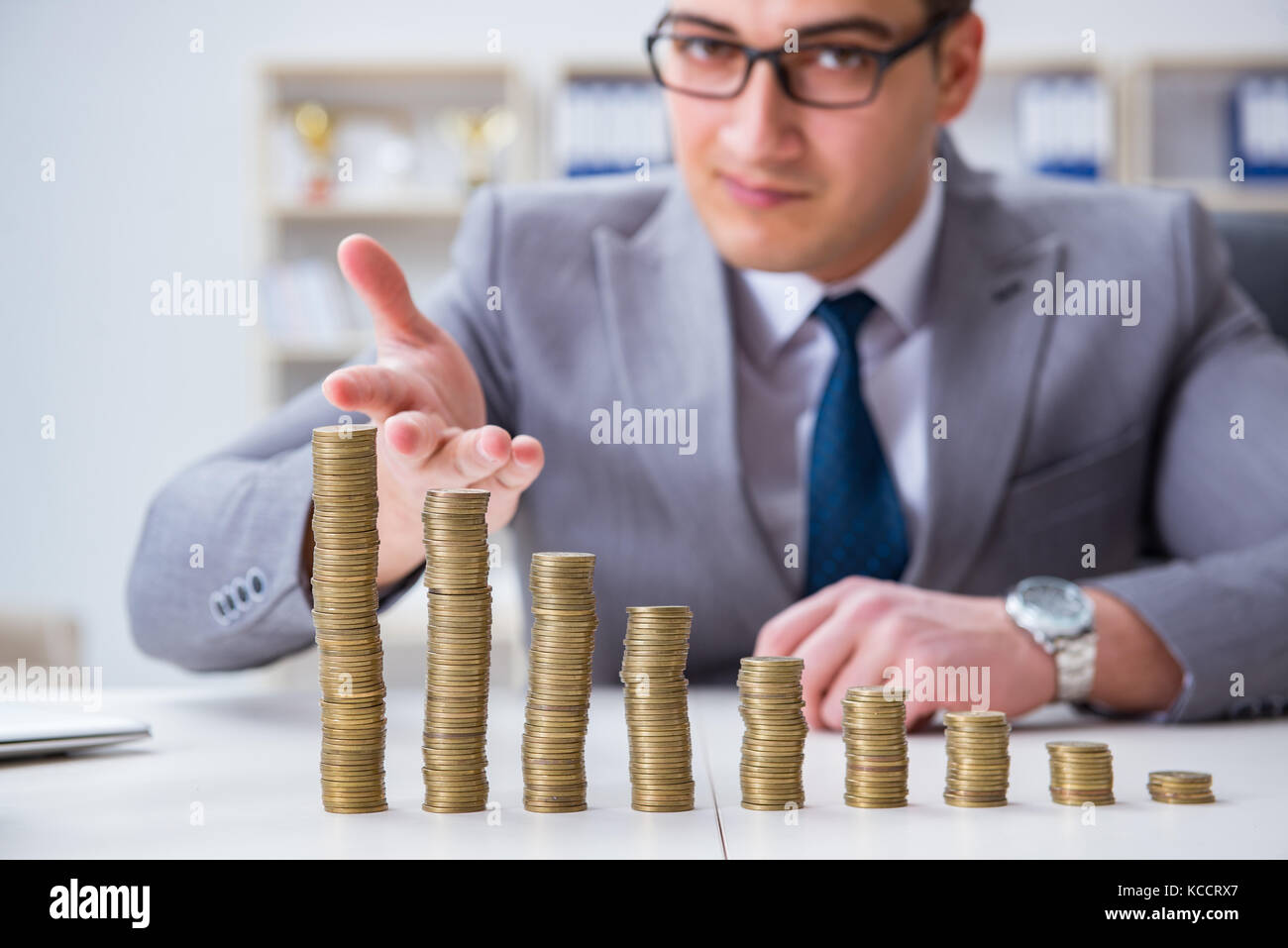 Businessman with golden coins in business growth concept Stock Photo ...