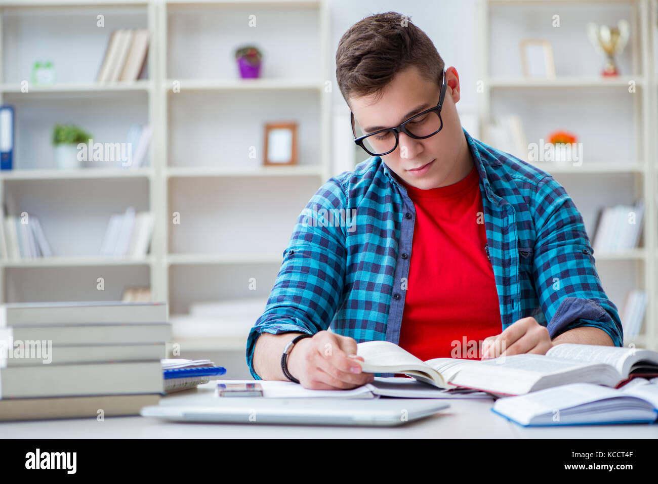 Student Preparing Young teenager preparing for exams studying at a desk indoors Stock ...