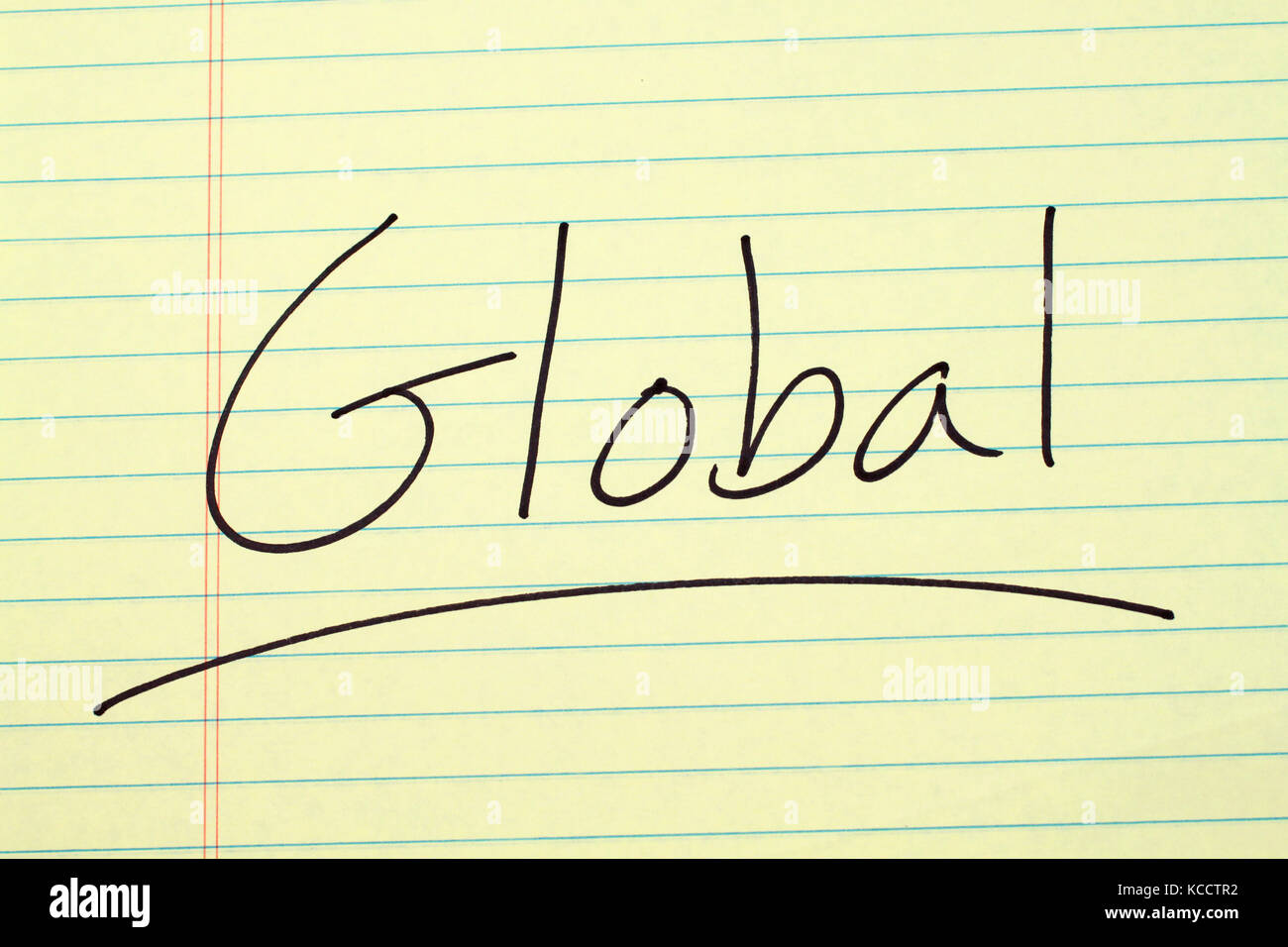 The word 'Global' underlined on a yellow legal pad Stock Photo