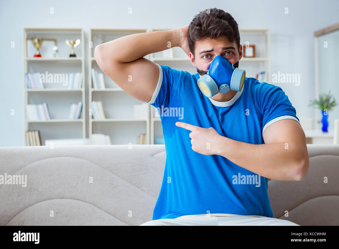 Man sweating excessively smelling bad at home Stock Photo Alamy