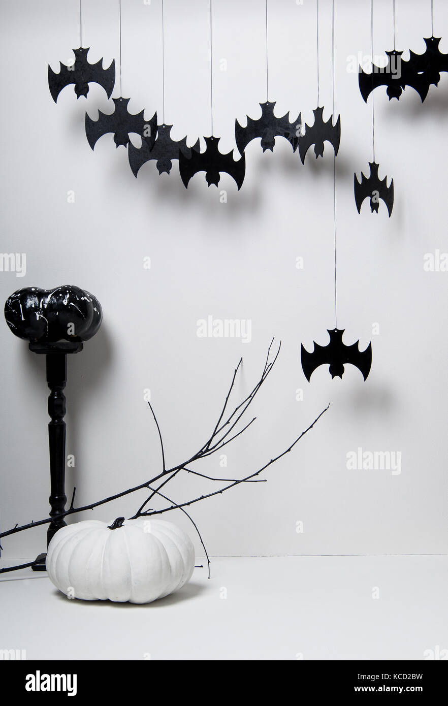 halloween with black silhouettes of bats and pumpkins with a branch of ...