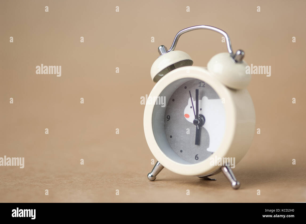 gray clock with a bear pattern on a brown blurred background Stock ...