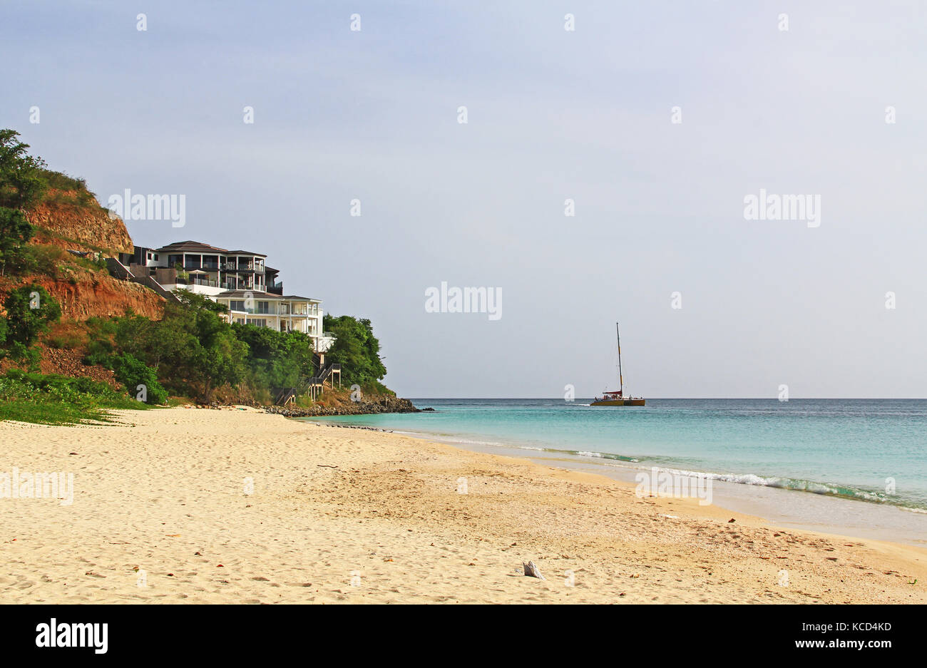 Mansion on a Cliff with Catamaran on the Sea Stock Photo
