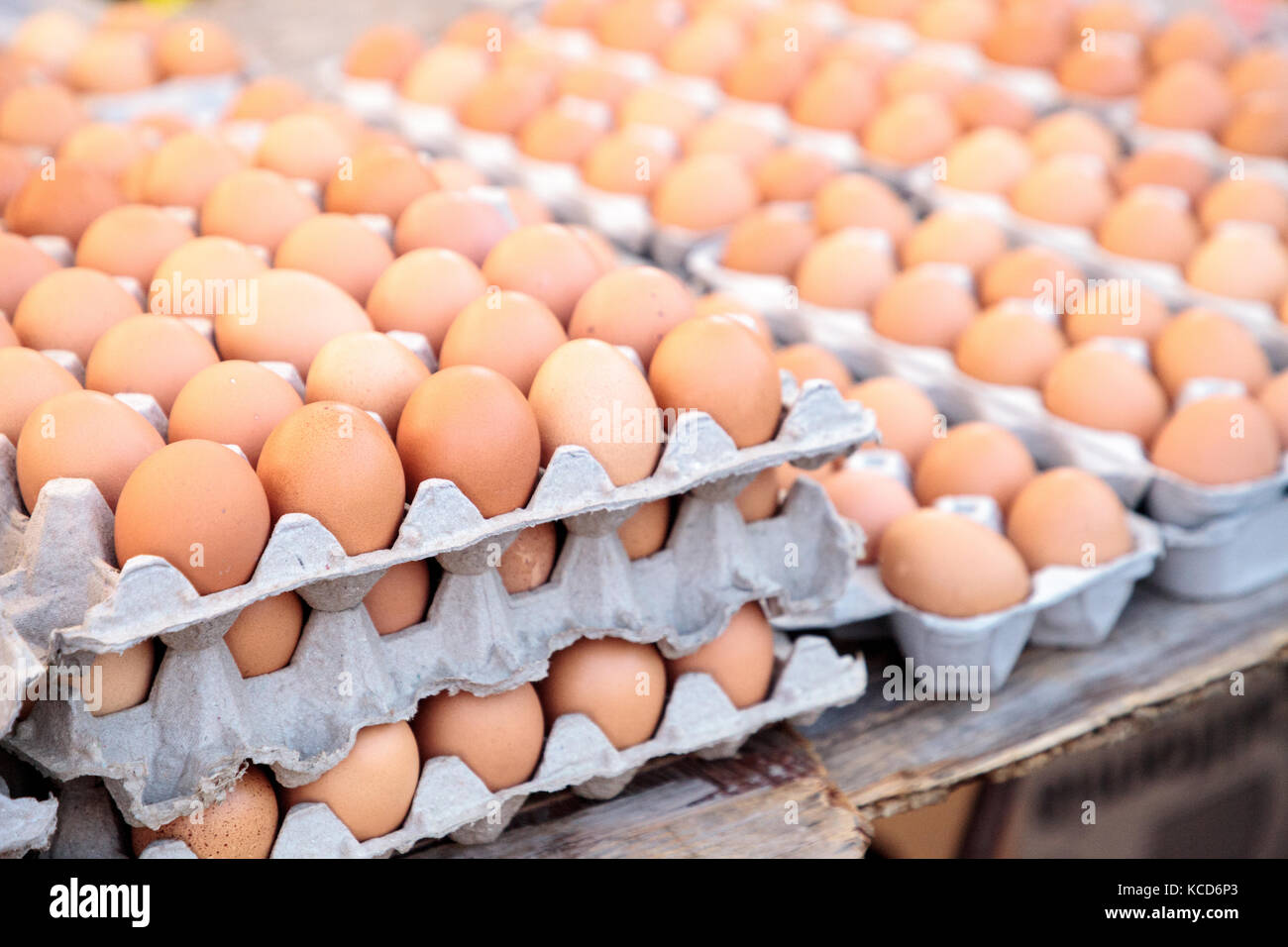 Egg Crates of brown and white eggs at a local farmers market from organic chickens. Stock Photo