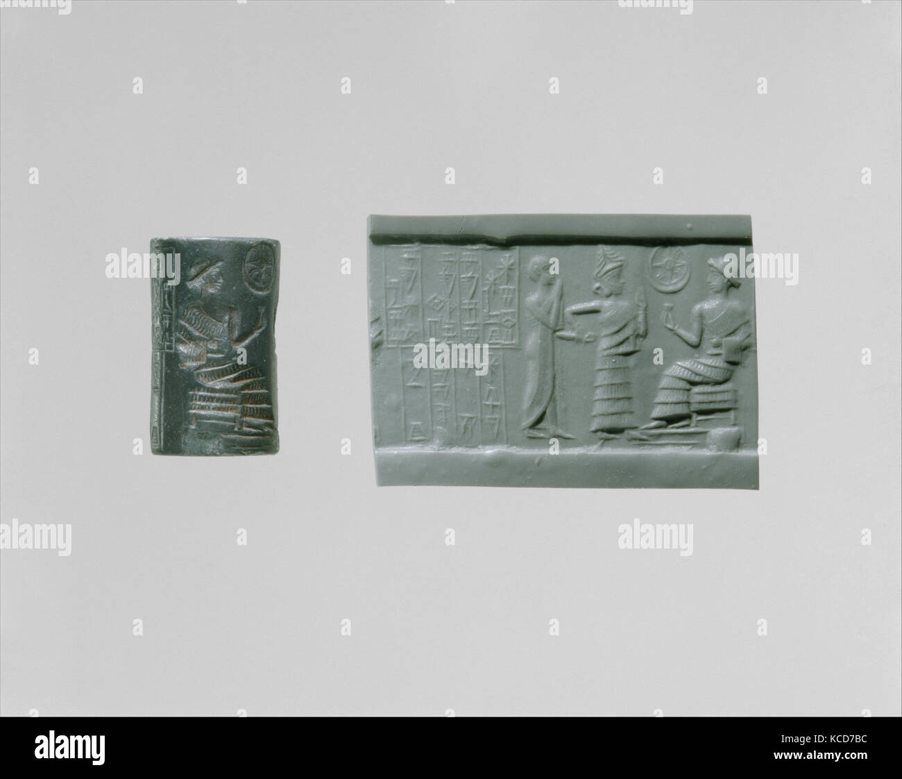 Cylinder seal: seated figure approached by a goddess leading a worshiper, ca. 2028–2004 B.C Stock Photo